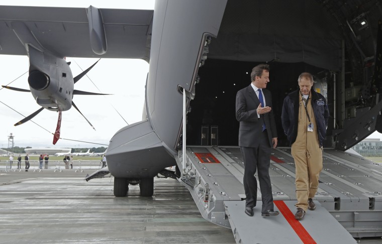 Image: Britain's Prime Minister David Cameron is shown around an Airbus A400M airlifter by chief test pilot Edward Strongman at the Farnborough Airshow 2012 in southern England